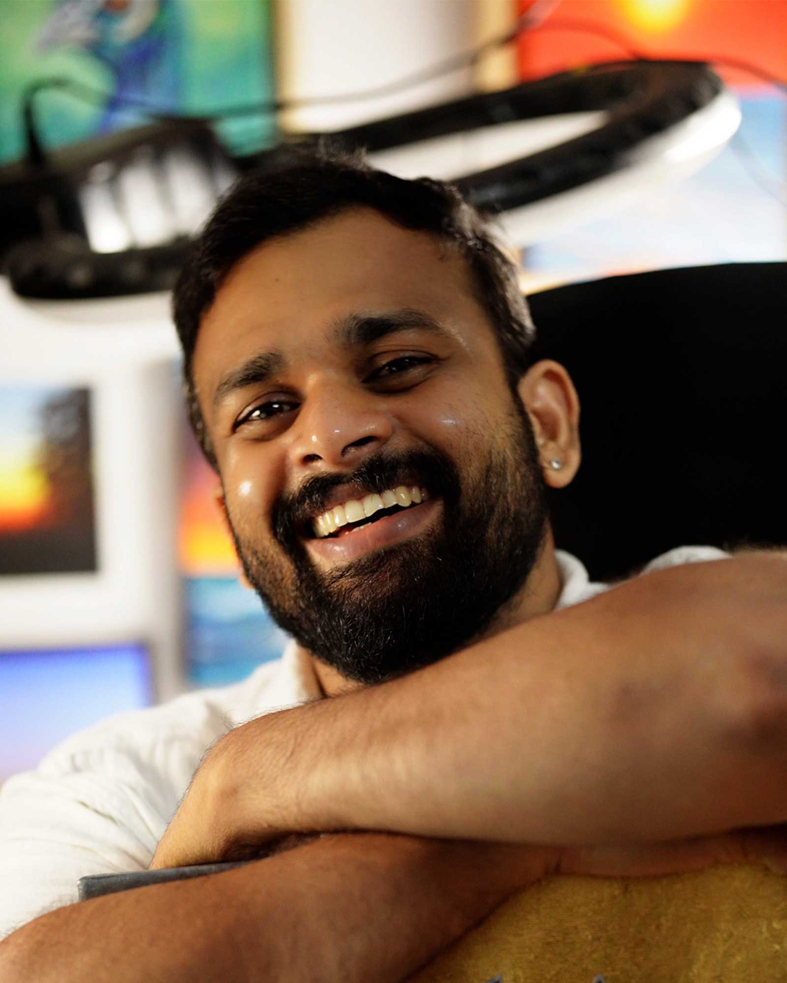 Artist Pratheesh smiling in his studio